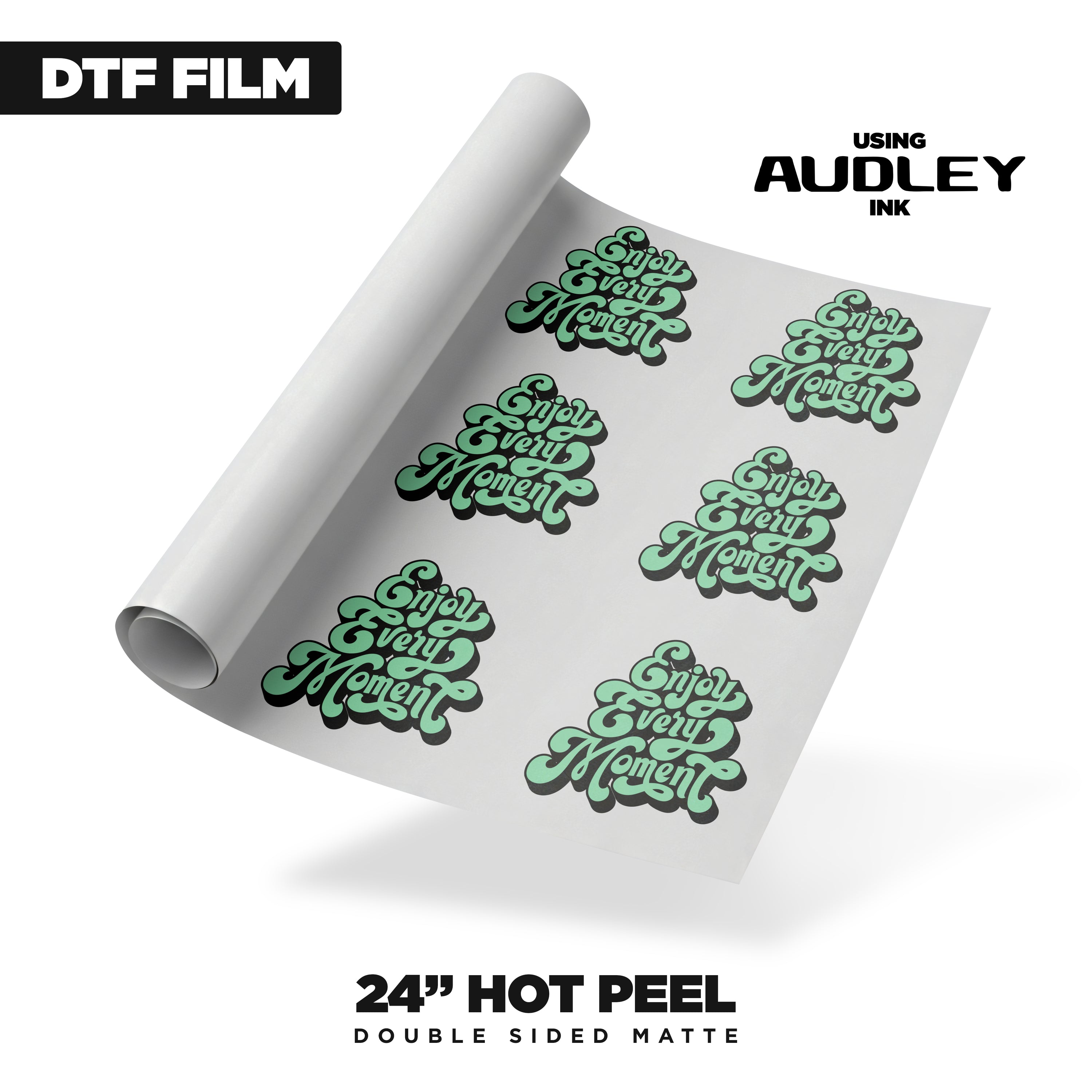A rolled sheet of DTF Locker Audley 24in Hot Peel DTF Film - Double Side Matte features green and black “Enjoy Every Moment” stickers and reads “DTF FILM,” “using AUDLEY ink,” and “24” hot peel double side matte.”.